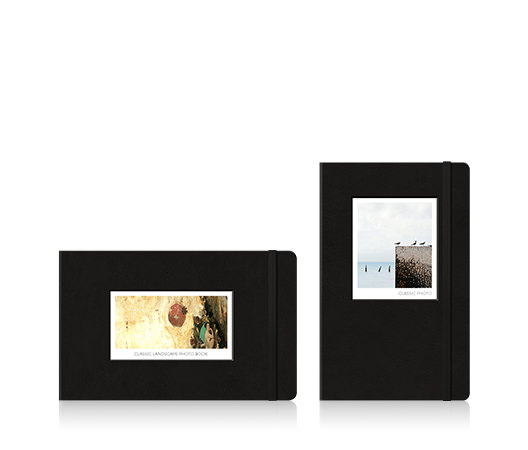Two Moleskine photo books. One landscape photo book with an artwork on the cover and one portrait photo book with birds at the beach on the cover