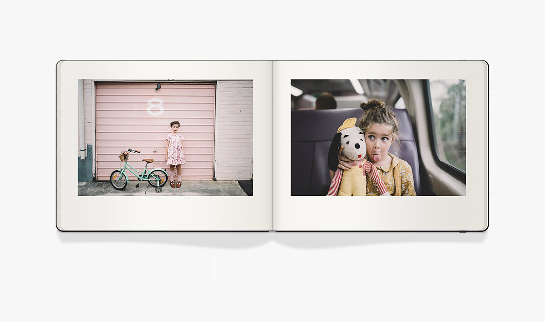 Open Moleskine Photo Book with photos of young girl wearing shades of pink