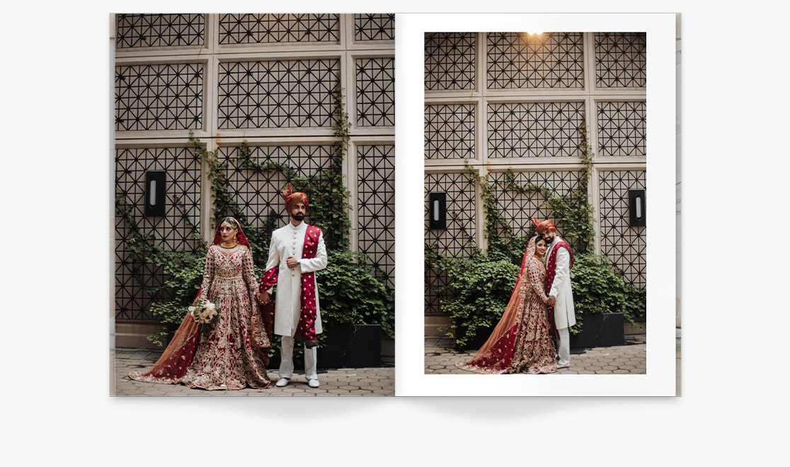 Open portrait wedding magazine with photos of Indian newlywed couple holding hands together in red and white wedding attire