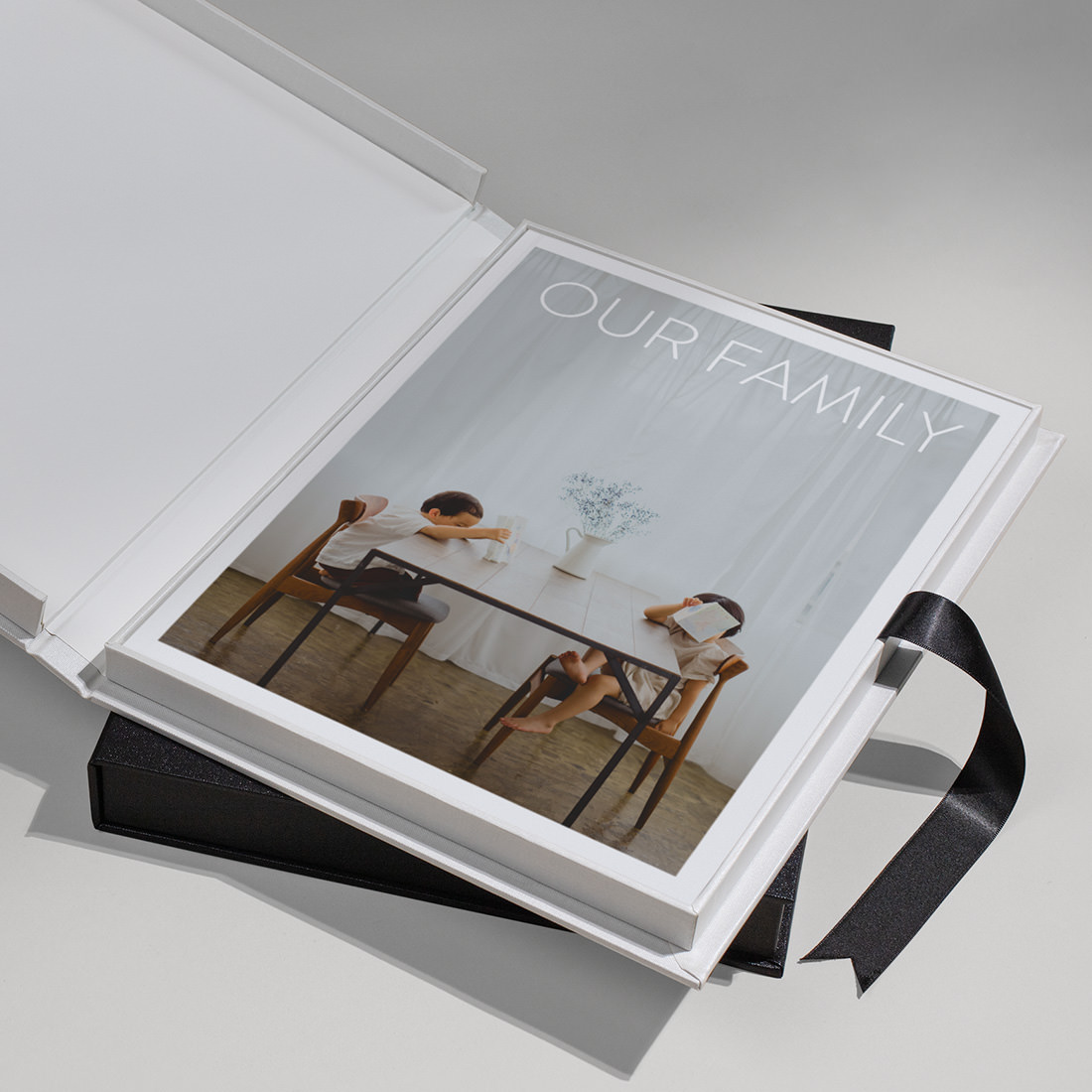 Open Black Buckram Presentation Box with Family Magazine laying on top