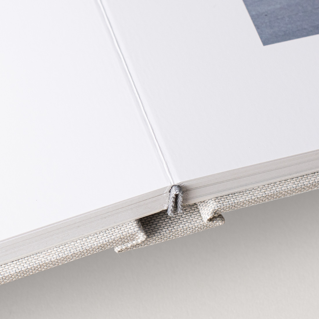 Close up of wedding guest book and its flush mount lay flat binding.