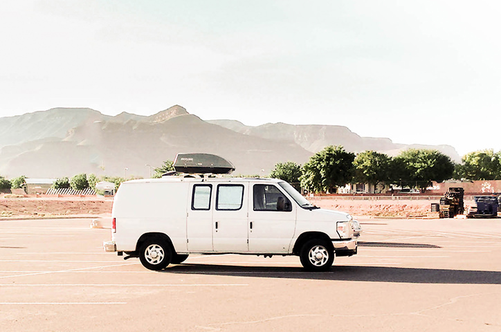 White van in desert landscape in the US.