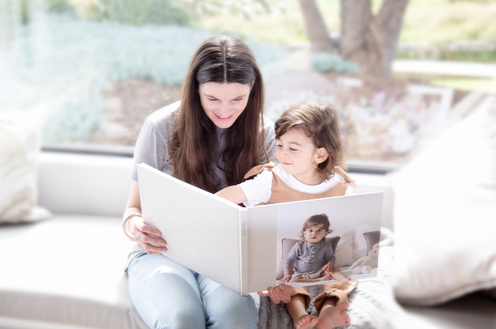 Mother and child looking through a photo book