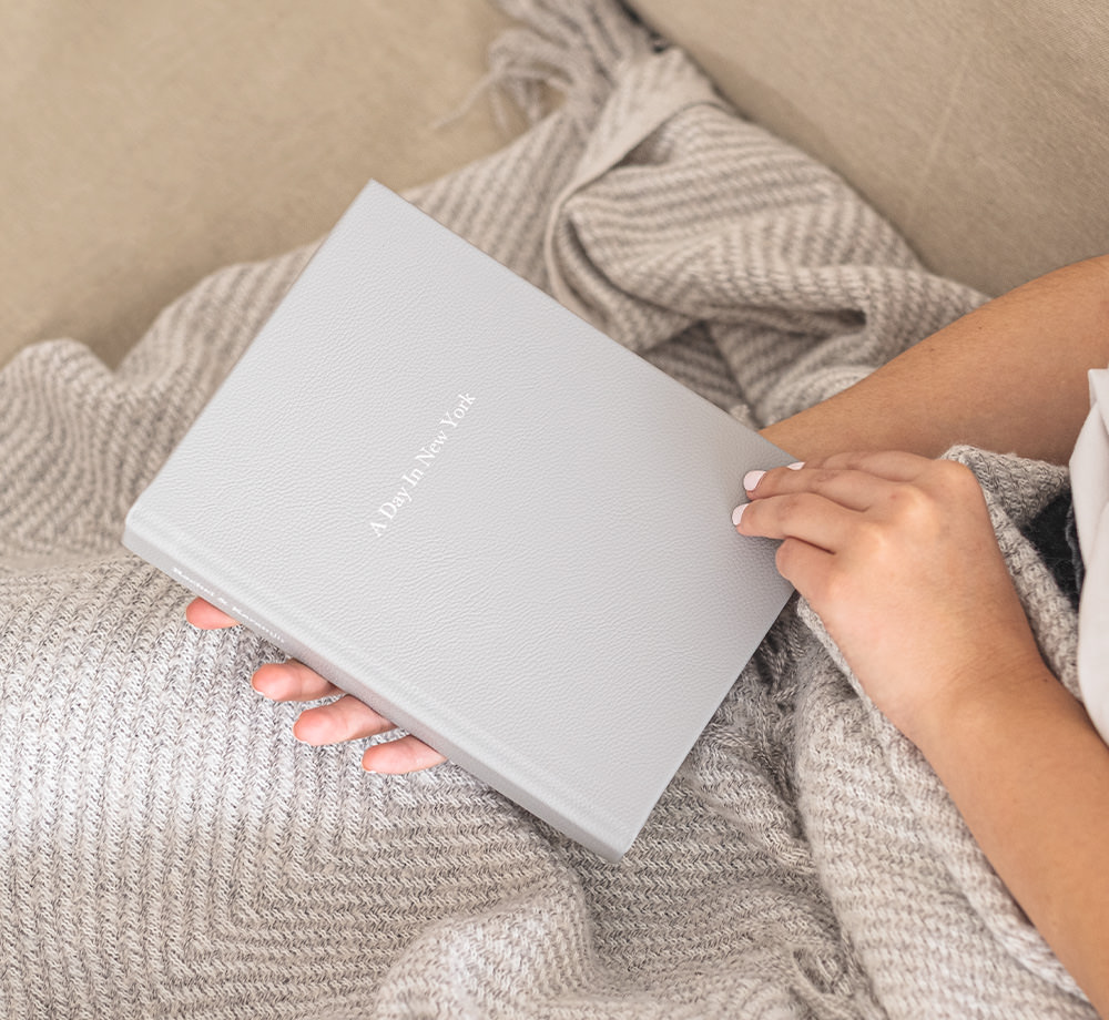 Woman holding medium premium photo album