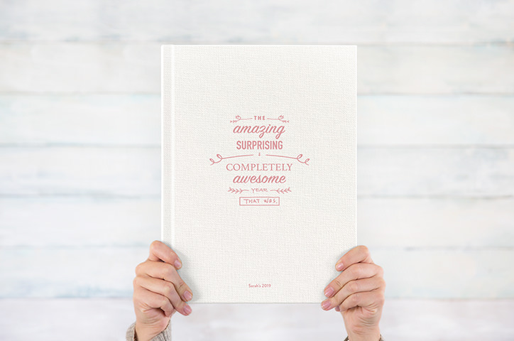 Photo book with UV cover text 'the amazing suprising and completely awesome year that was'
