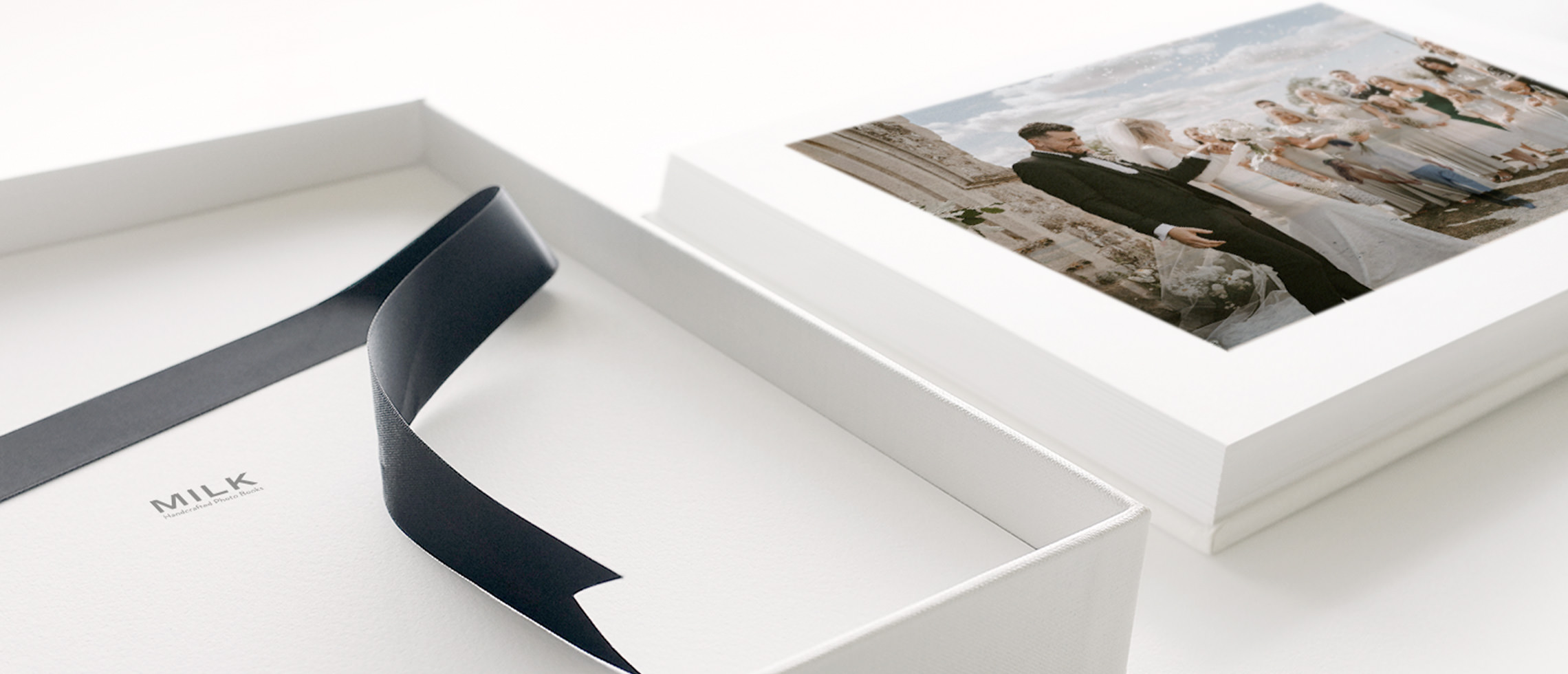 Wedding Photo Album next to open Presentation Box with black silk lift-out ribbon